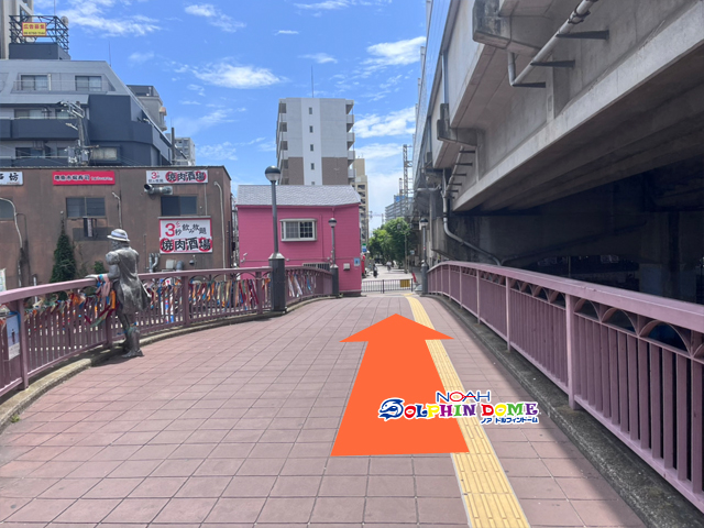 電車沿いの橋を渡る